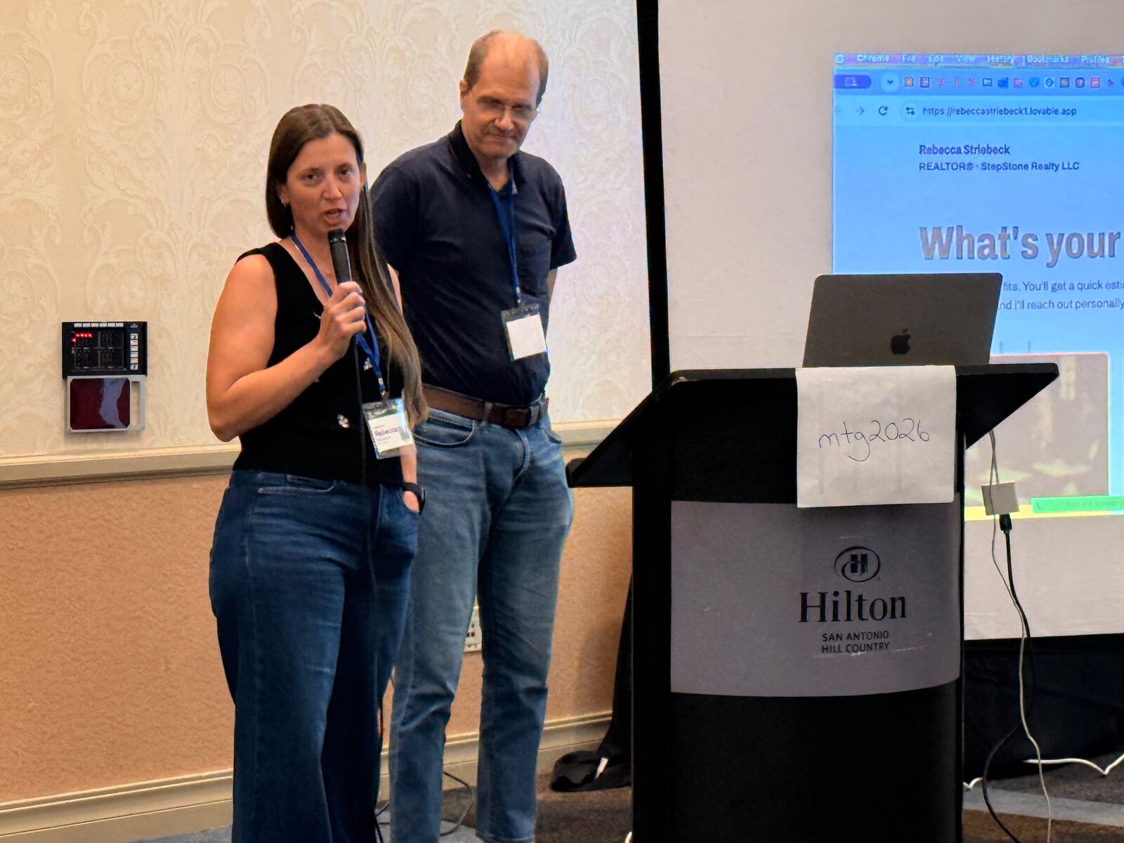 Two speakers teaching from the front of the room